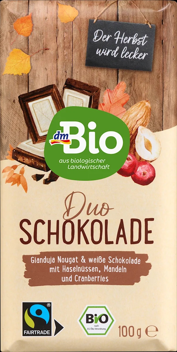 dmBio temna čokolada gianduja z nugatom in bela čokolada z lešniki, mandlji in brusnicami 100 g - Akcija v trgovini Dm
