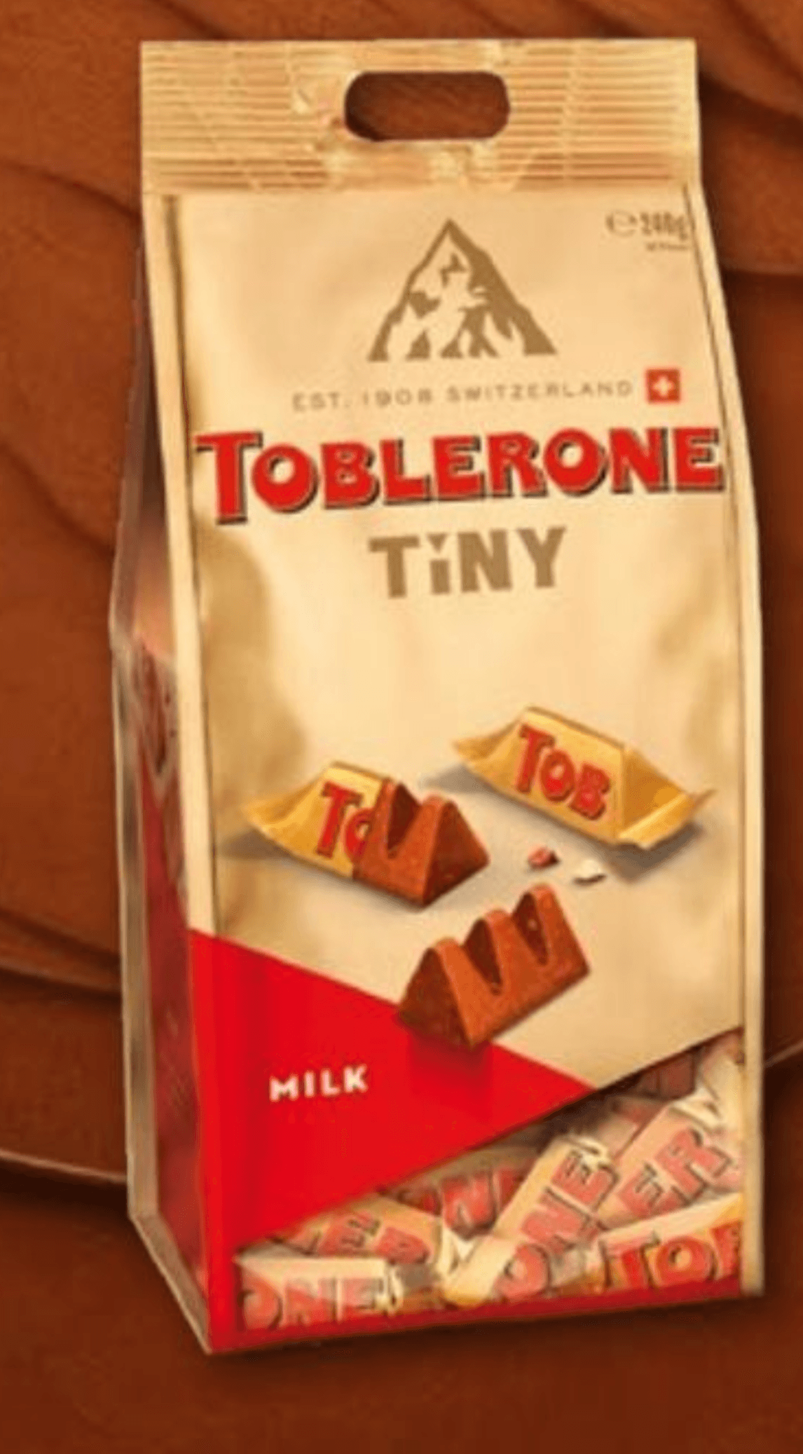 TOBLERONE Tiny mlečna in bela čokolada z medom in mandljevim nugatom 240 g - Akcija v trgovini Kompas Shop